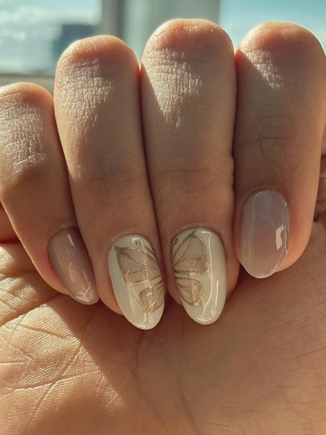 Neutral almond manicure with fine butterfly nail art by Mary