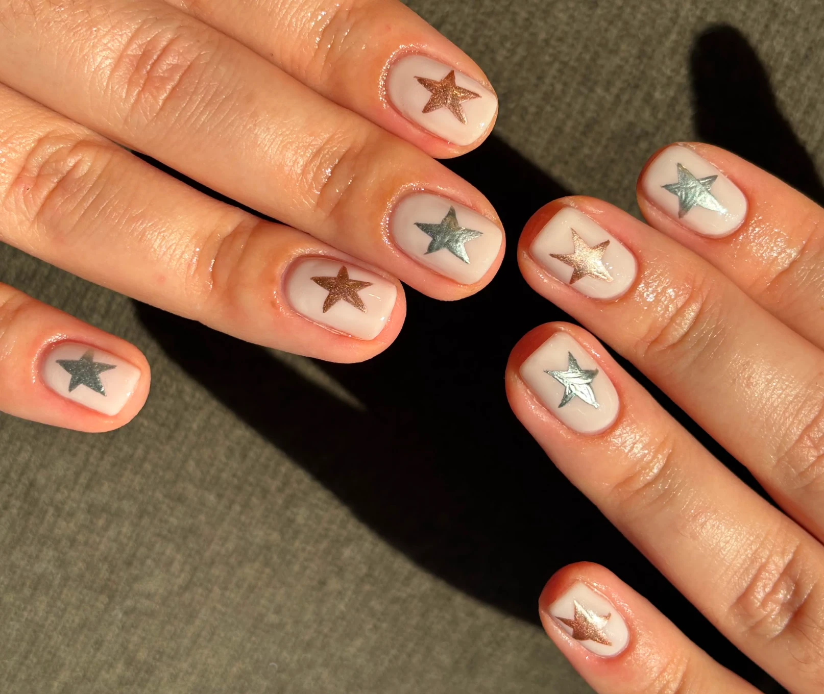 Metallic star and chrome almond nail art by Mary
