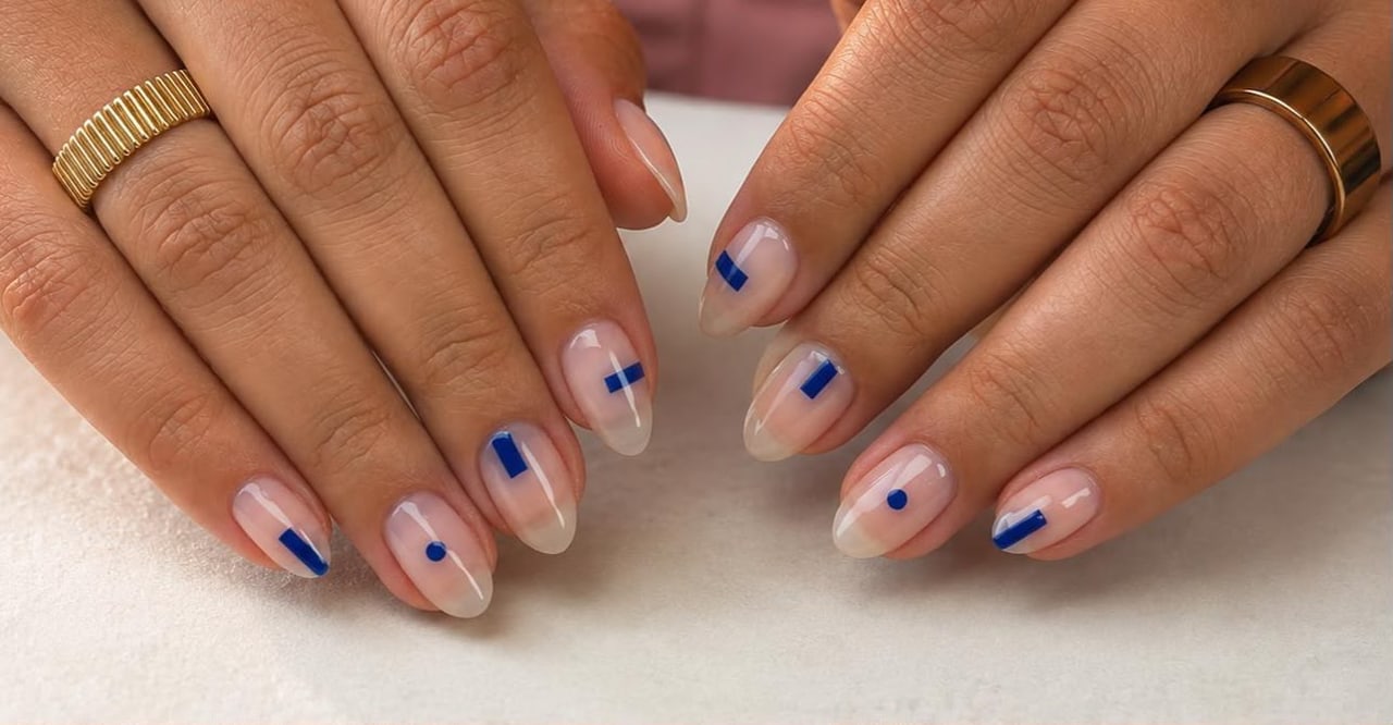 Sheer neutral almond manicure with blue geometric nail art created by Mary
